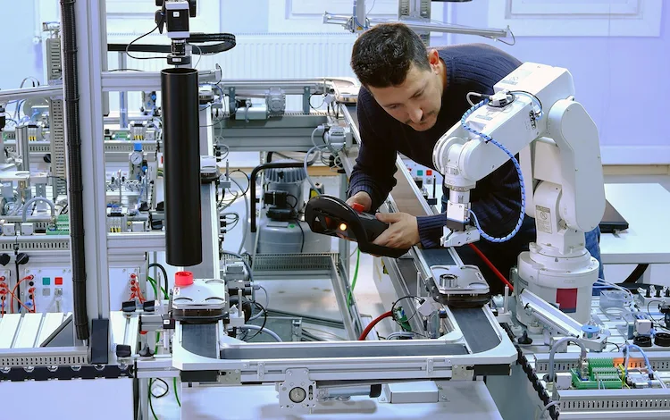 Guy working with robotic arm